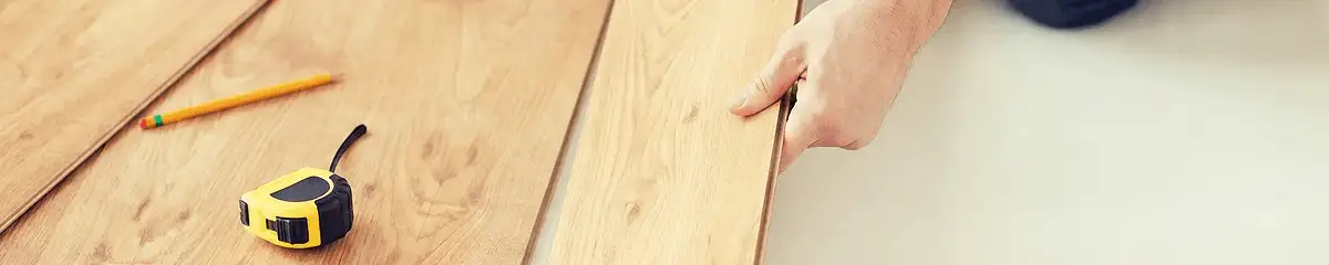 A professional installing wood flooring in New Orleans, LA