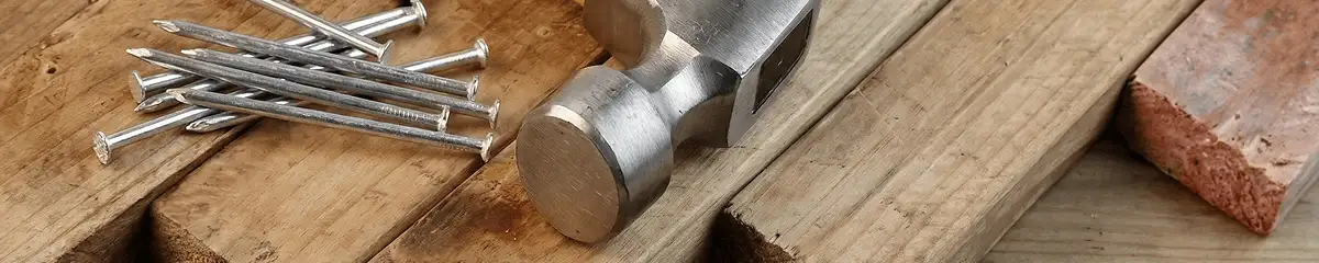 Hammer and nails on hardwood flooring boards in New Orleans, LA
