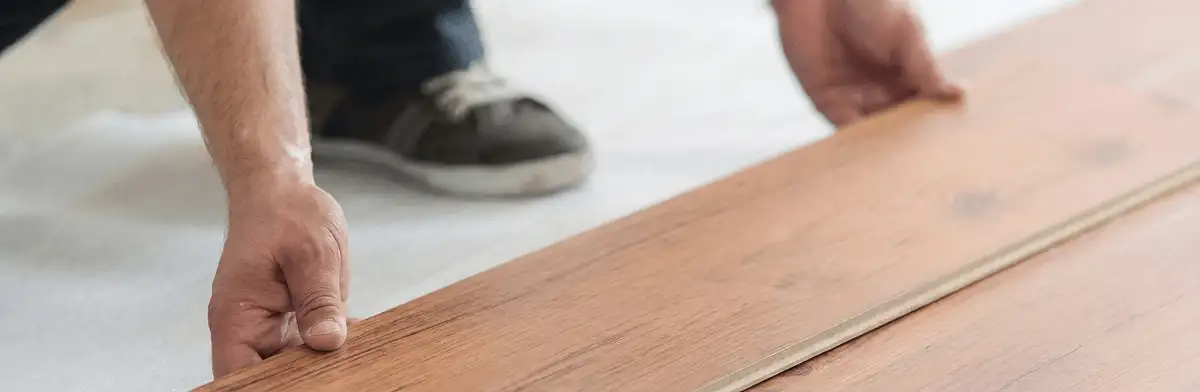 A professional installing laminate flooring in New Orleans, LA