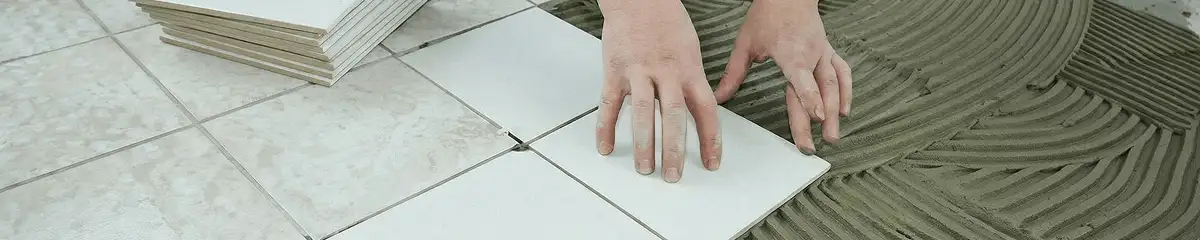 Professional installing white tile floors in New Orleans, LA